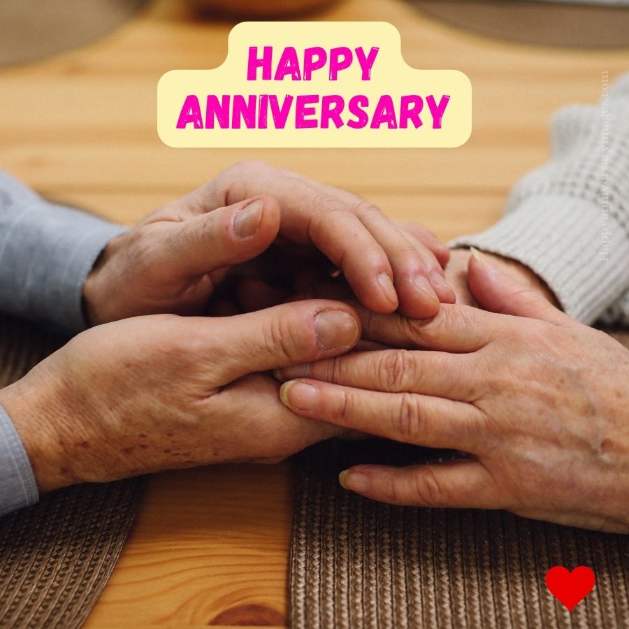 Elderly couple holding hands wishing happy anniversary to each other